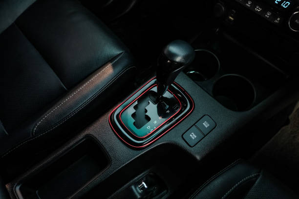 istock automatic transmission shift selector in the car interior. Closeup a manual shift of modern car gear shifter. 1295446560