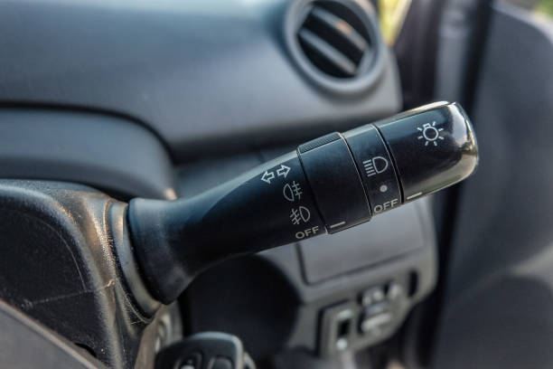 istock Switch off lights in a car. close-up Car integrated turning indicator with headlight switch toggle. 1295446566