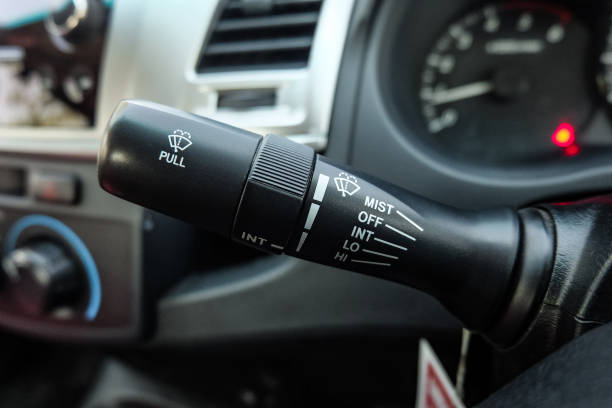 istock Windscreen wiper control switch in car. Wipers control. Modern car interior detail. adjusting speed of screen wipers in car. 1295446568