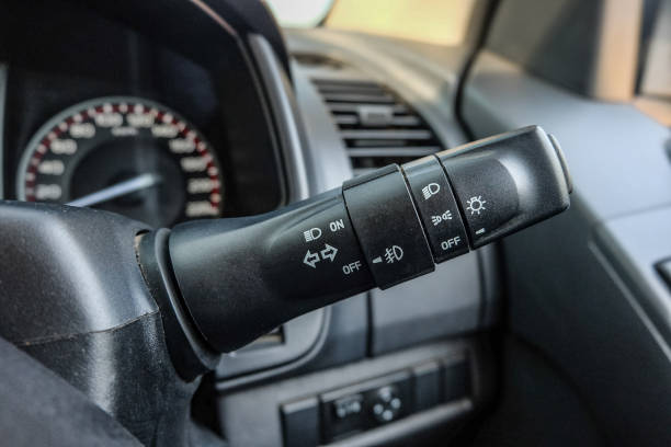 istock Switch off lights in a car. close-up Car integrated turning indicator with headlight switch toggle. 1295446571
