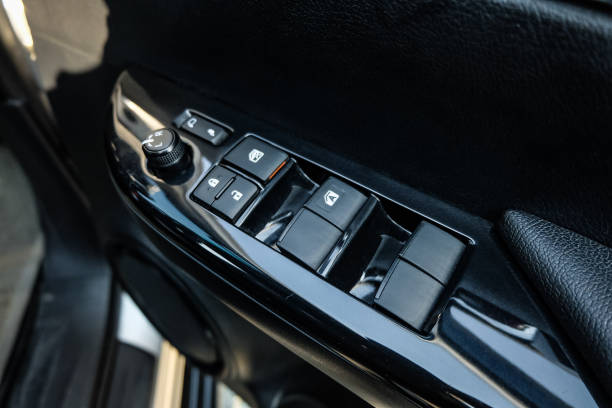 istock Car arm rest with Control Panel. Door Lock & Mirror Control. window adjustment buttons, door lock. Photography of a modern car. 1295446582