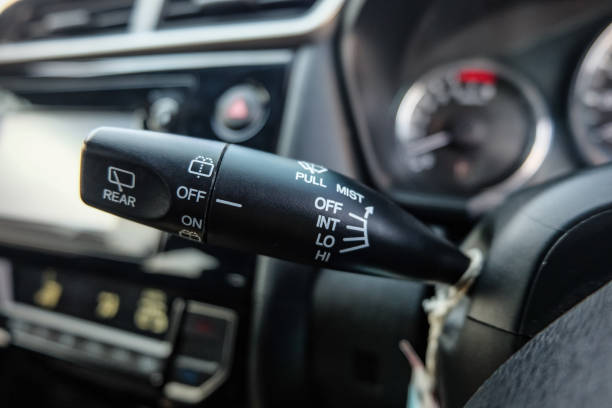 istock Windscreen wiper control switch in car. Wipers control. Modern car interior detail. adjusting speed of screen wipers in car. 1295446585