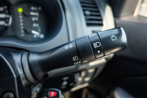 istock Switch off lights in a car. close-up Car integrated turning indicator with headlight switch toggle. 1295446588
