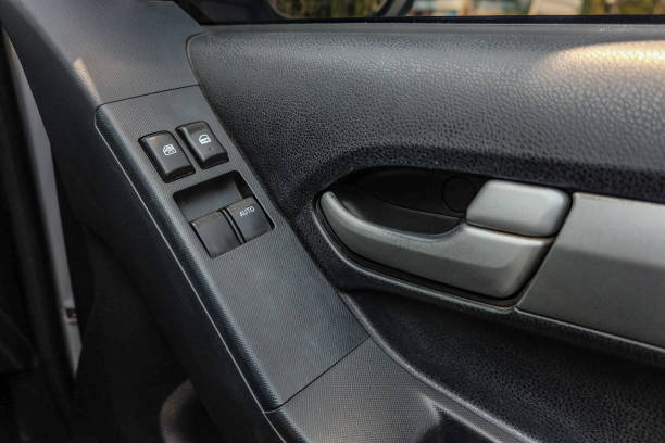 istock Car arm rest with Control Panel. Door Lock & Mirror Control. window adjustment buttons, door lock. Photography of a modern car. 1295446589
