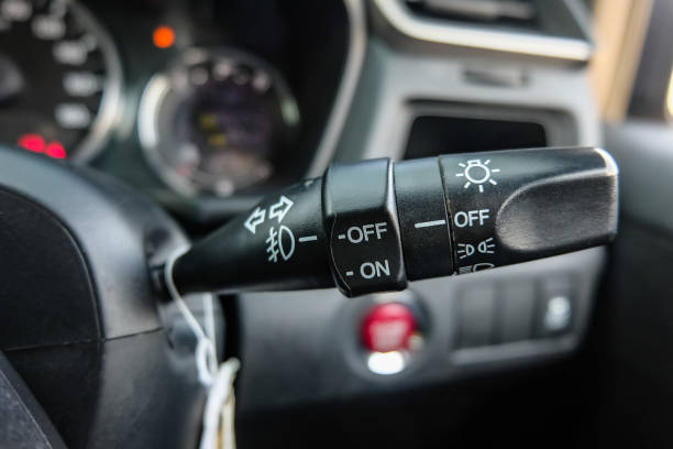 istock Switch off lights in a car. close-up Car integrated turning indicator with headlight switch toggle. 1295446620