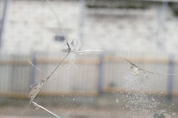 Cracked glass with chips caused by shrinkage of building structures