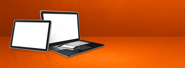istock Laptop, mobile phone and digital tablet pc on orange office desk. Banner background 1295448865