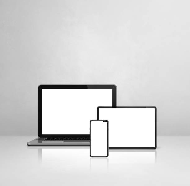 istock Laptop, mobile phone and digital tablet pc on white concrete office desk 1295449376