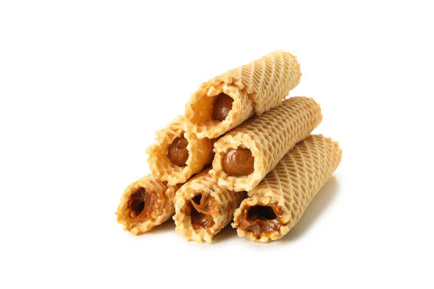 istock Wafer rolls with condensed milk isolated on white background 1295449960