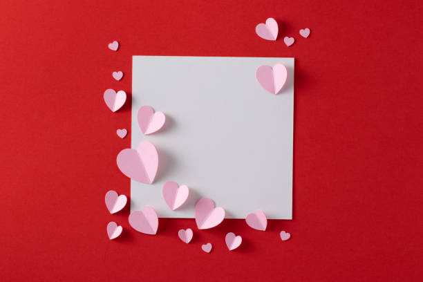 istock Pink paper hearts with blank white note for Valentine’s Day message. 1295450668