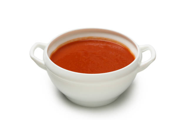 istock Bowl of tomato soup isolated on white background 1295450770