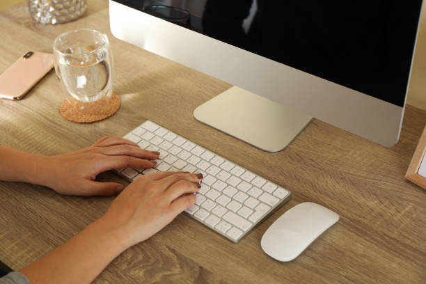 istock Woman working on desktop computer on wooden table 1295451835