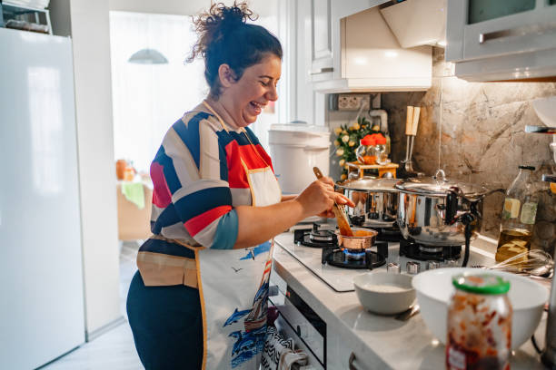 Female Vlogger Making Social Media Female Vlogger Making Social Media Video About Cooking for the Internet. Culinary Vlog. Baking Blog.overweight  Woman Cooking and Show Baking for Social Media. Video Recording at Kitchen. woman making healthy dinner stock pictures, royalty-free photos & images