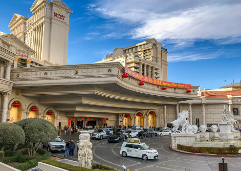 Las Vegas, Nevada, USA - February 2019:  Taxis and cars queuing to pick up people from the front of the Caesars Palace Hotel in Las Vegas.