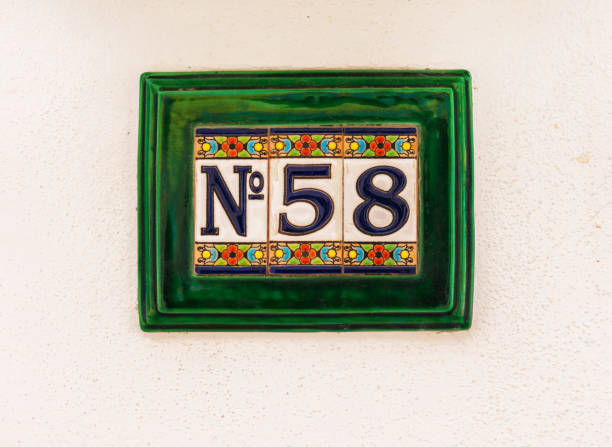 istock Decorative ceramic house number 58 tile on the wall, characteristic decorative element 1295457812