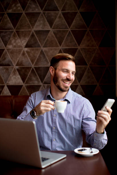 istock Young man working on laptop in the cafe 1295458368