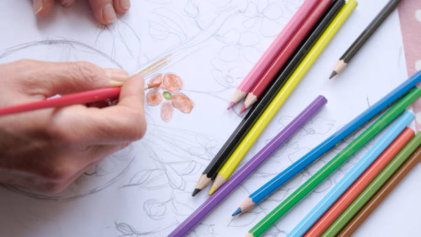 istock Woman hands painting a flower. 1295458418