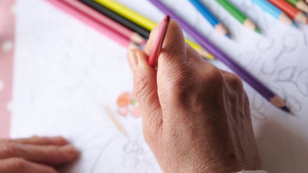 istock female hand holding paintbrush 1295458458