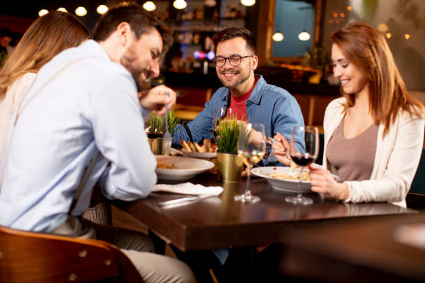 istock Young people having dinner in the restaurant 1295458610