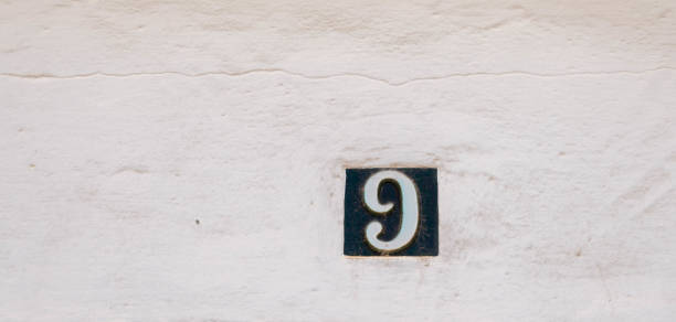 istock Decorative ceramic house number 9 tile on the wall, characteristic decorative element, 1295458675