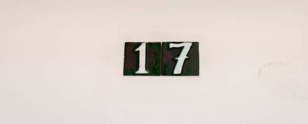 istock Decorative ceramic house number 17 tile on the wall, characteristic decorative element, 1295458689