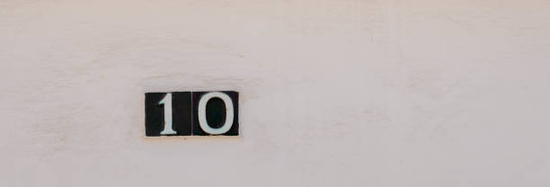 istock Decorative ceramic house number 10 tile on the wall, characteristic decorative element, 1295458691