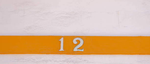 istock Decorative ceramic house number 12 tile on the wall, characteristic decorative element, 1295458824