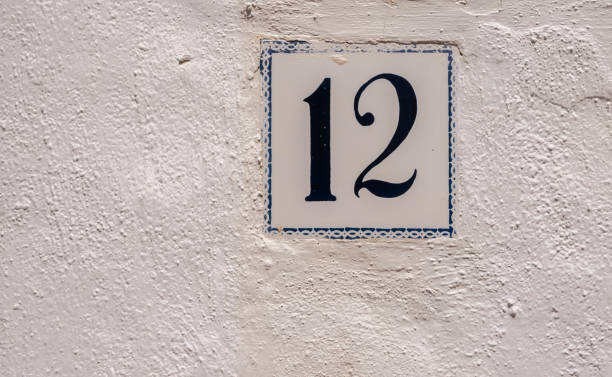 istock Decorative ceramic house number 12 tile on the wall, characteristic decorative element, 1295458853
