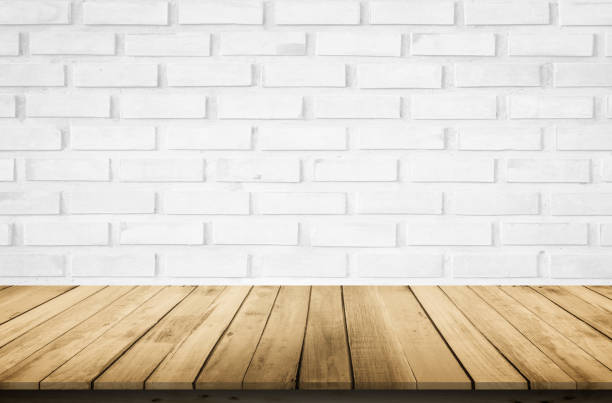 istock Empty wooden table top on white brick wall background, Design wood terrace white. Perspective for show space for your copy and branding. Can be used as product display montage. Vintage style concept. 1295459788