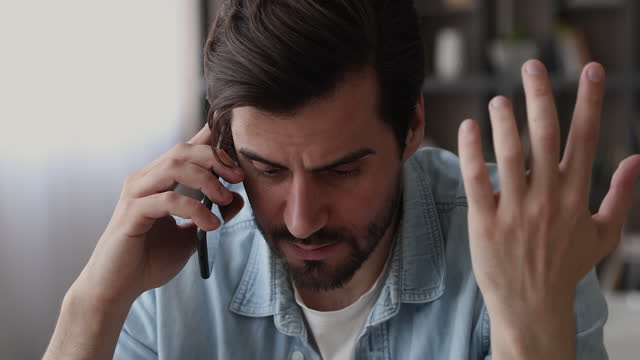 Man feels upset listening bad news on the phone