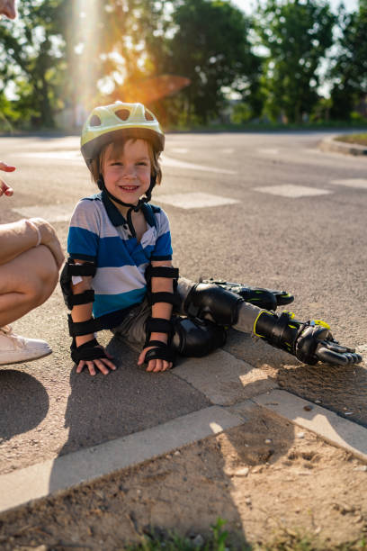 istock Smiling boy fell on the street 1295462681
