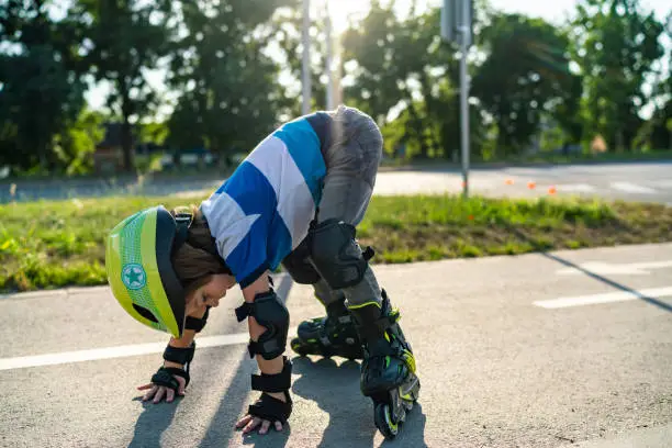 Photo of Little boy gets up after he falling off the roller skates