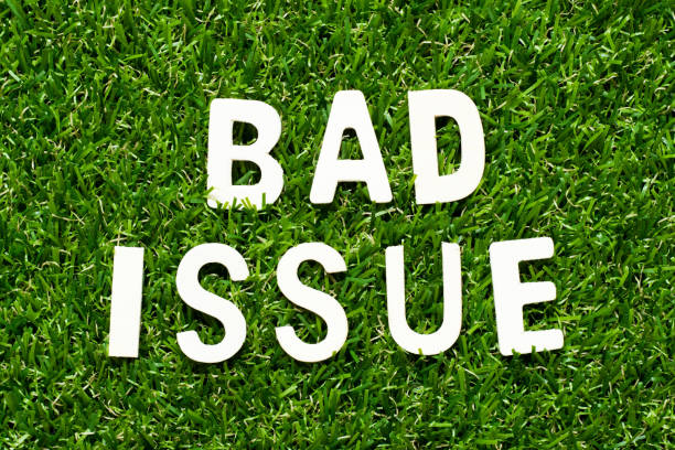 istock Wood alphabet letter in word bad issue on green grass background 1295464088
