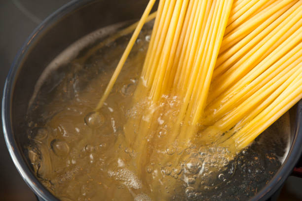 istock Cooking Bucatini Pasta in pot on electric stove. 1295468476