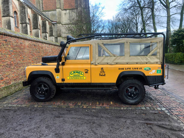 Veere, the Netherlands - Januari 2, 2021: Yellow Land Rover parked on a public parking lot. Nobody in the vehicle.