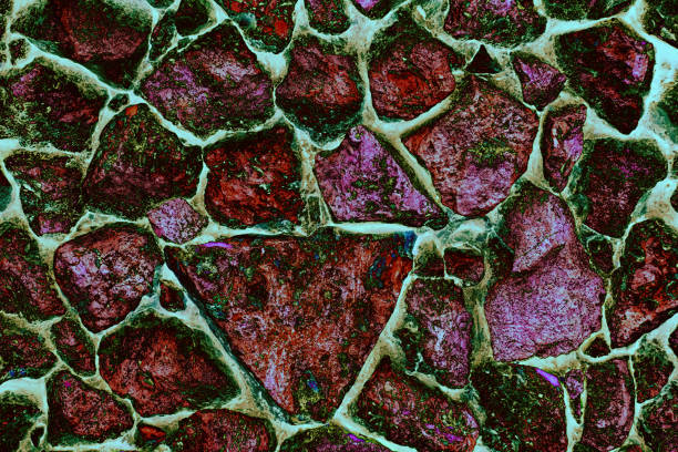 istock Coloured wall made of large stones 1295470224