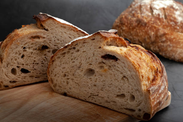 istock Sliced sourdough bread on dark cement background. 1295471590