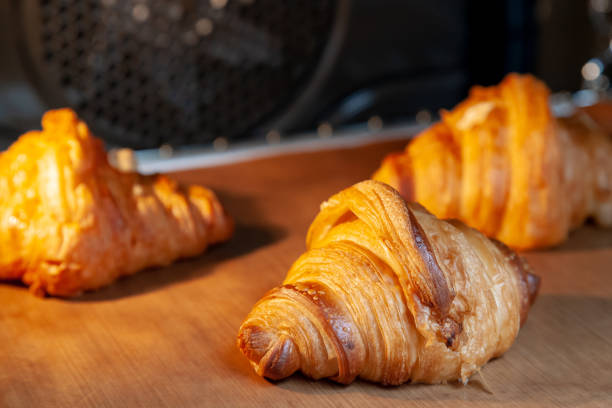 istock Baking croissants in an oven. 1295471653