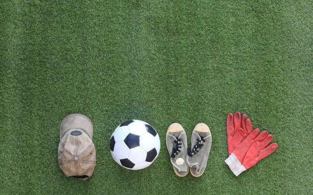 istock old soccer ball isolated on green grass 1295476663