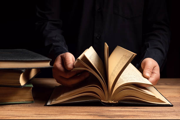 Man illuminates the darkness by reading a book
