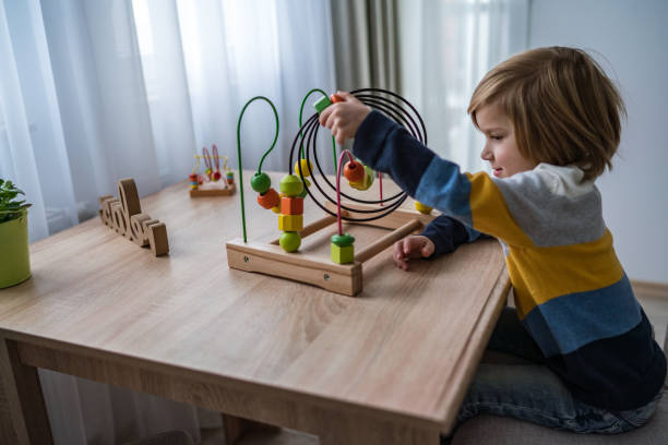 istock Boy with wooden toy 1295478093