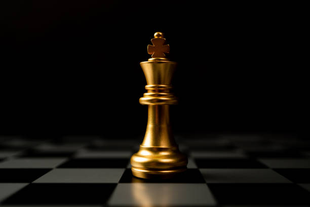 istock Golden Chess King standing alone on the chessboard 1295480786