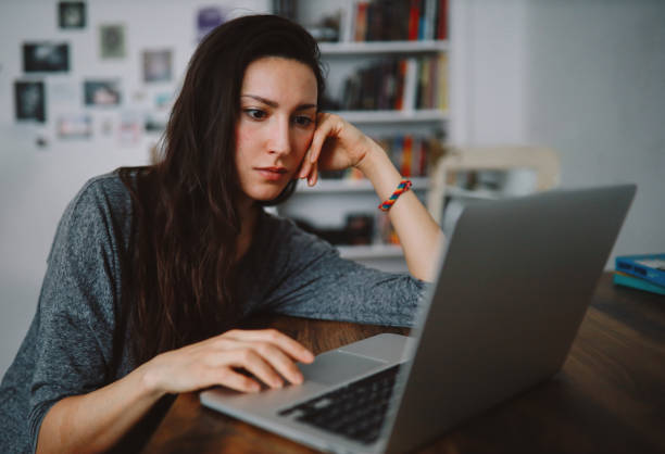istock woman sitting at the desk, working from home 1295482145