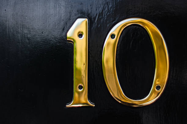 istock A bold brass number 10 on a black painted door 1295483179
