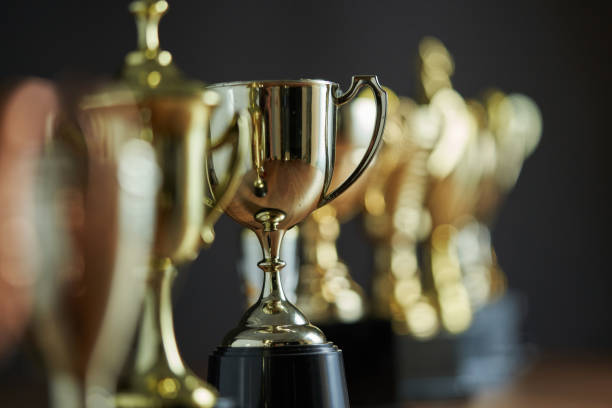 group of trophies in a row group of trophies in a row trophy award stock pictures, royalty-free photos & images