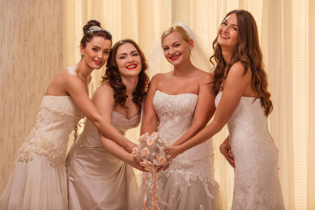 istock Four brides holding one wedding bouquet 1295484313