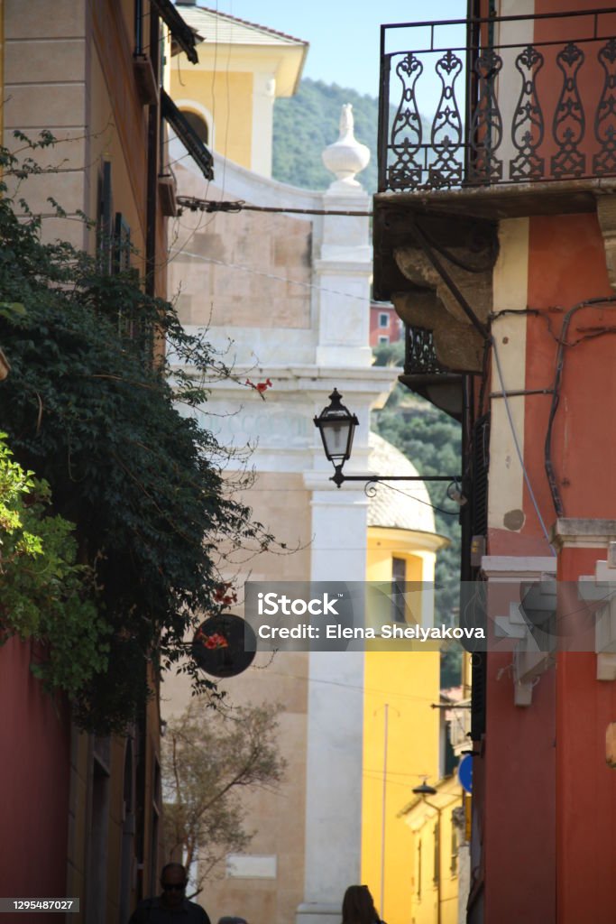 Cozy street in the old town Yellow and red houses in Italy Alley Stock Photo