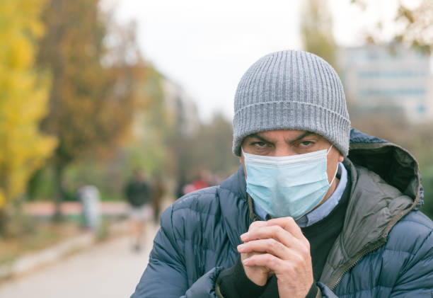 istock Incorrect way of sneezing or coughing 1295488038