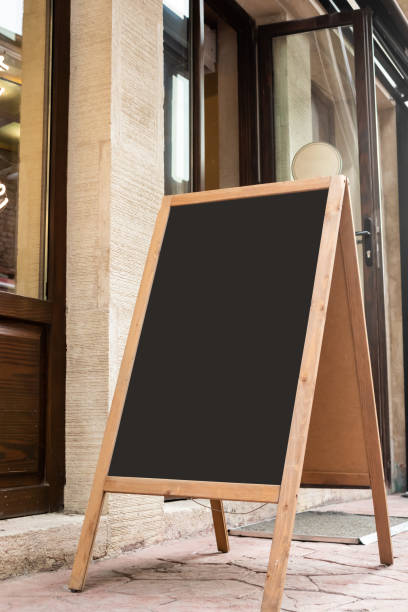 istock Blank board stand mock up white signage outdoor, restaurant menu template 1295488297