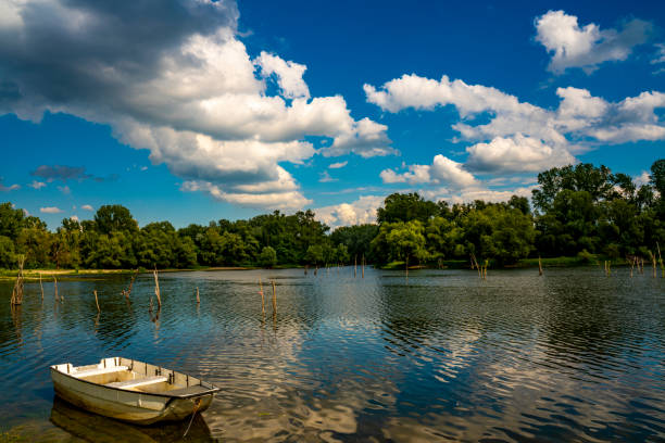 Small wooden boat on the calm lake